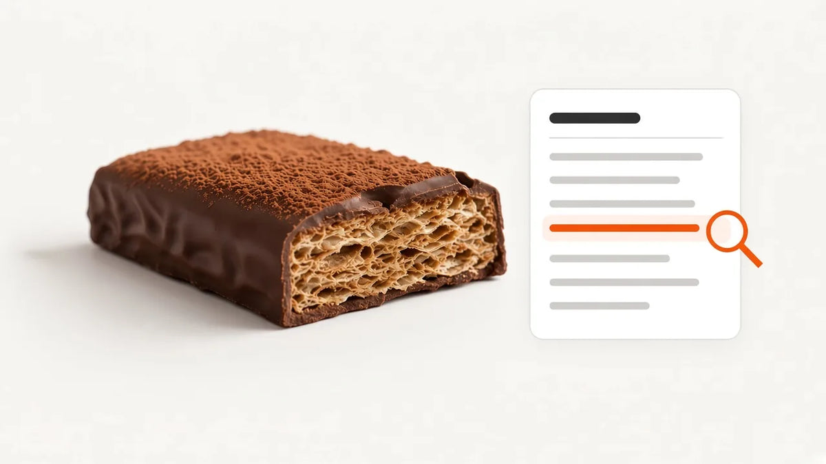 Chocolate protein wafer bar broken to show layers next to a soft nutrition label checklist